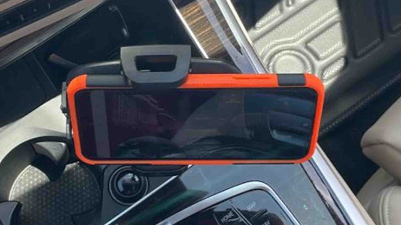 Adjustable car mount holding smartphone horizontally in center console